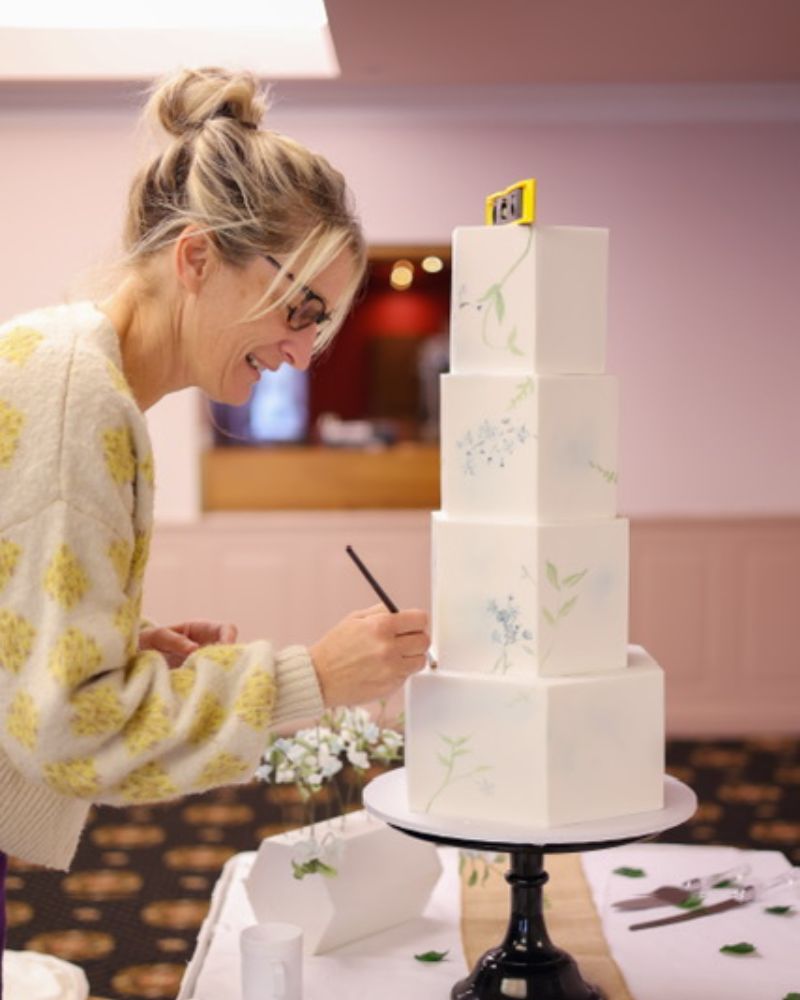 Alison decorating a wedding cake