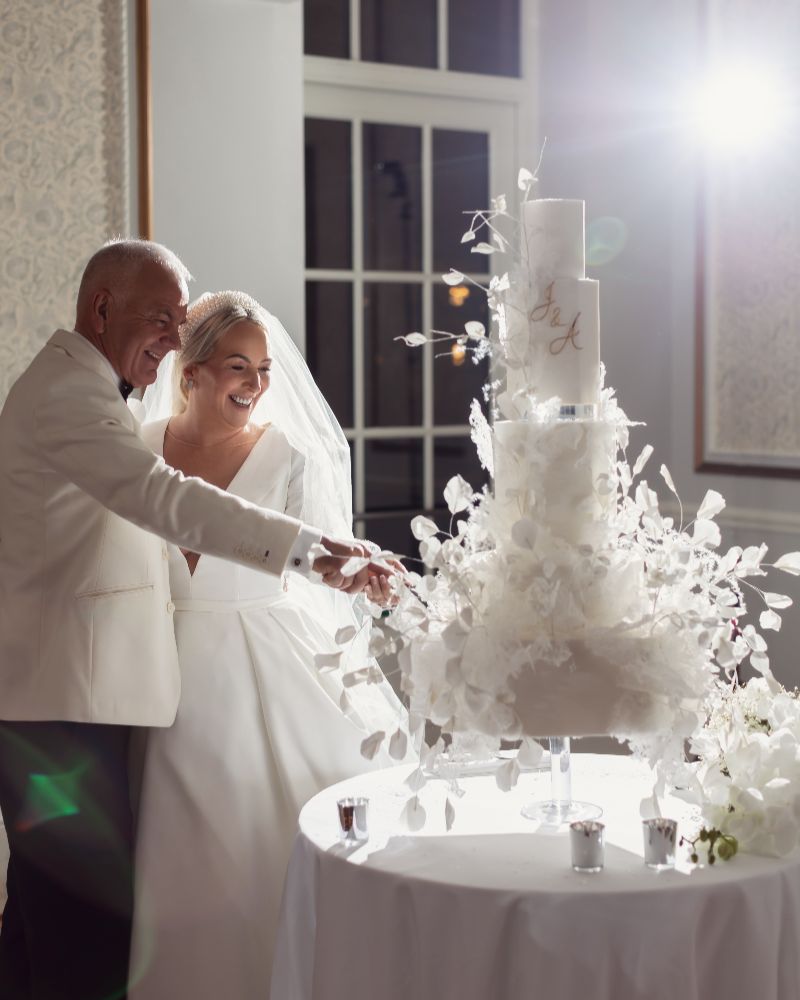 bride and groom cutting their wedding cake